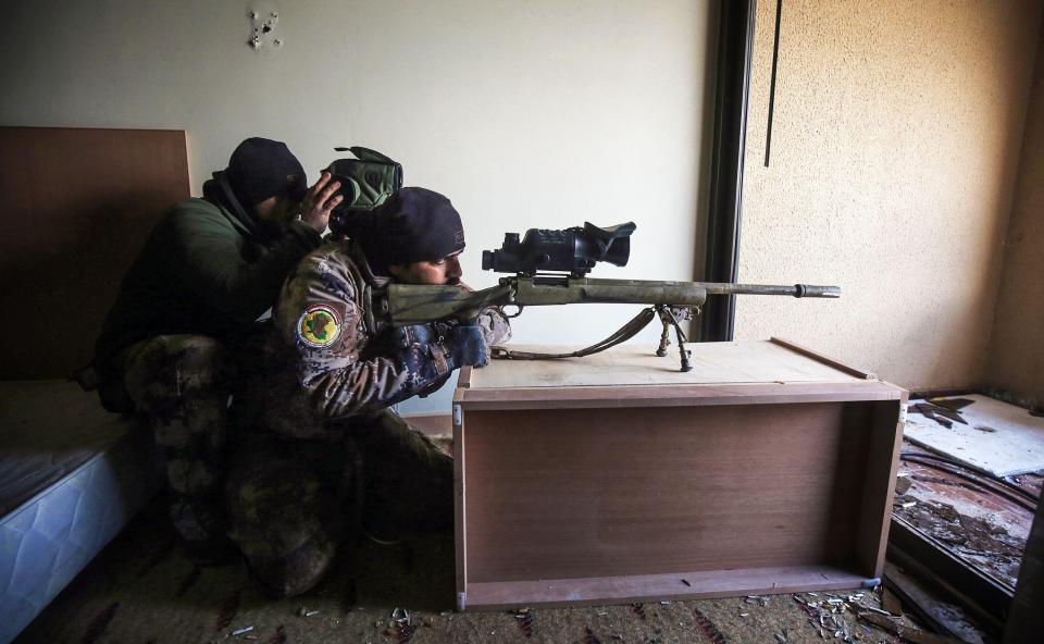  Iraqi counter-terrorism forces take position inside a room in the Oberoi hotel