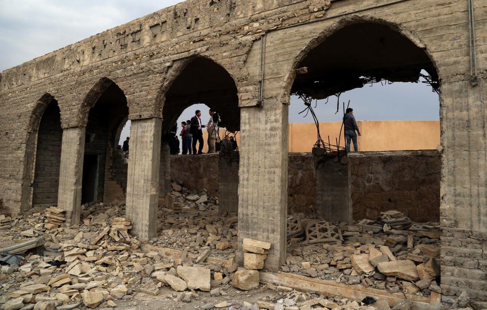  People inspect the destroyed Mosque of The Prophet Younis, or Jonah, in Mosul