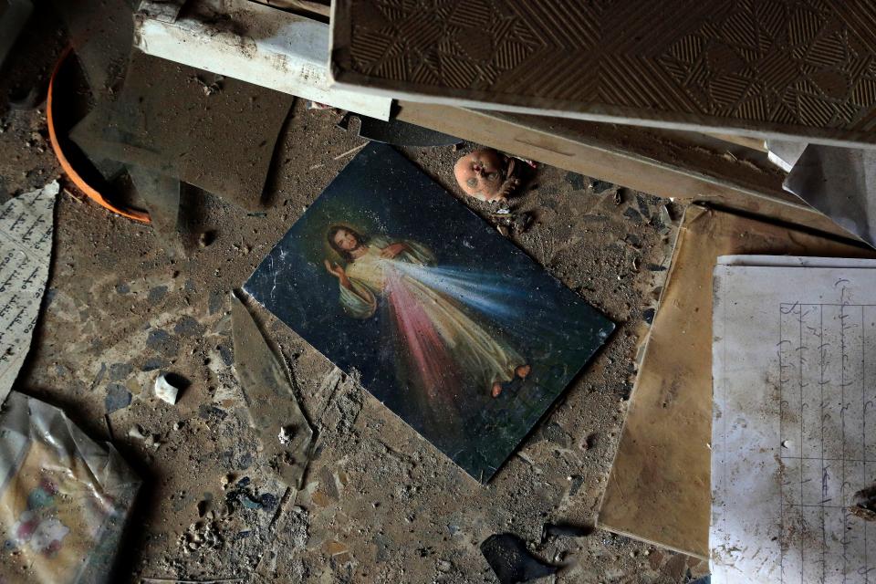  A picture of Jesus Christ lies on the ground inside a church damaged by Islamic State militants during their occupation of the predominantly Christian town of Tilkaif