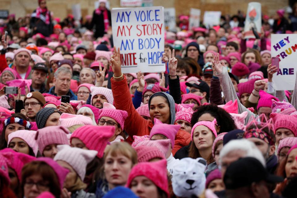  Women wearing pink hats with cat ears gathered in Washington DC