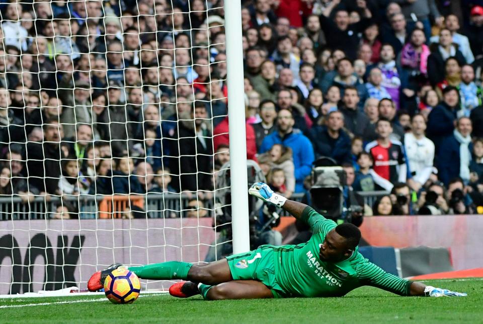  Carlos Kameni is forced to scamper back and clear off the line after poor control