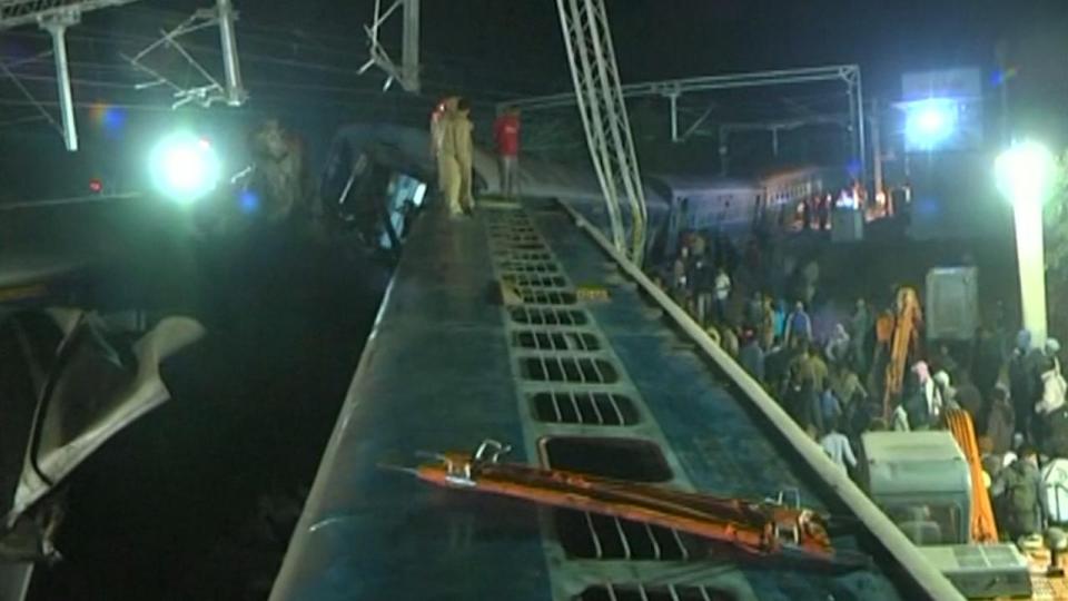  A crowd of locals looked on as rescuers battled to find more survivors in the wreckage