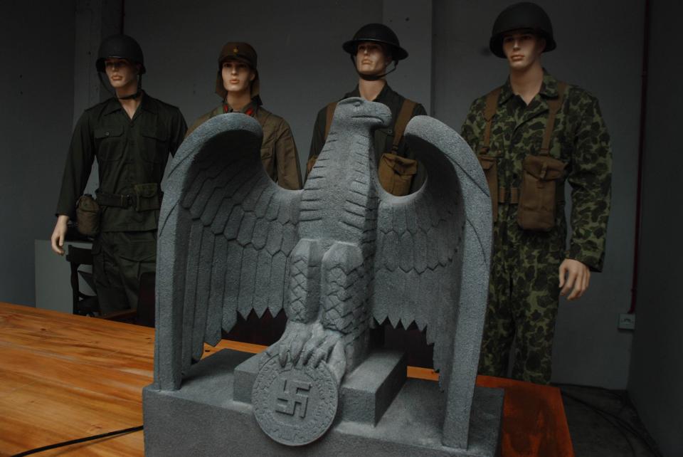  Military uniforms in front of a Third Reich eagle