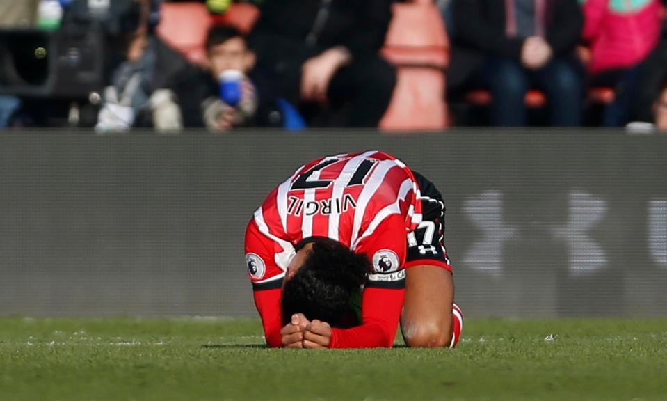  Virgil van Dijk crumples to the floor after being caught in the box by Jamie Vardy