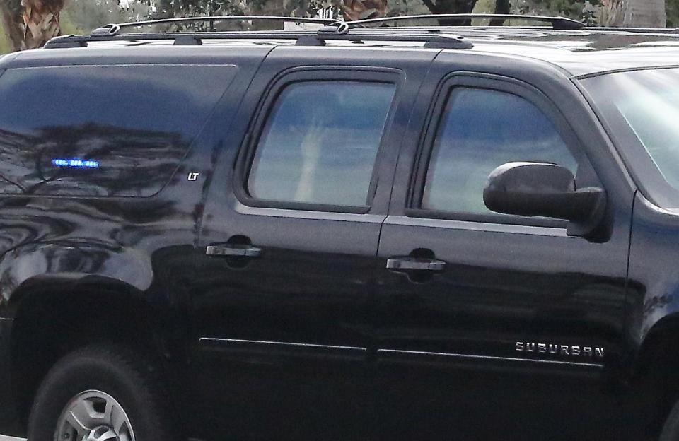  Obama looks downcast as he is driven back from a gym workout today - in a hugely downsized motorcade