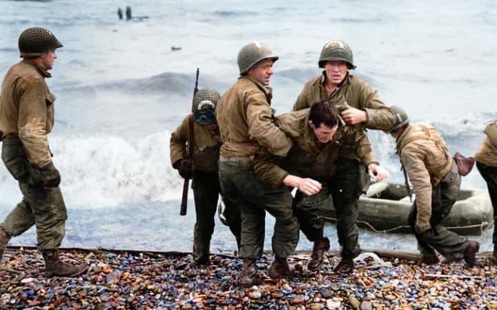  This D-Day scene captures a small naval craft on the bloodied beach where thousands of troops lost their lives. Many were cut down by German machine-gun fire before they even reached the shore line