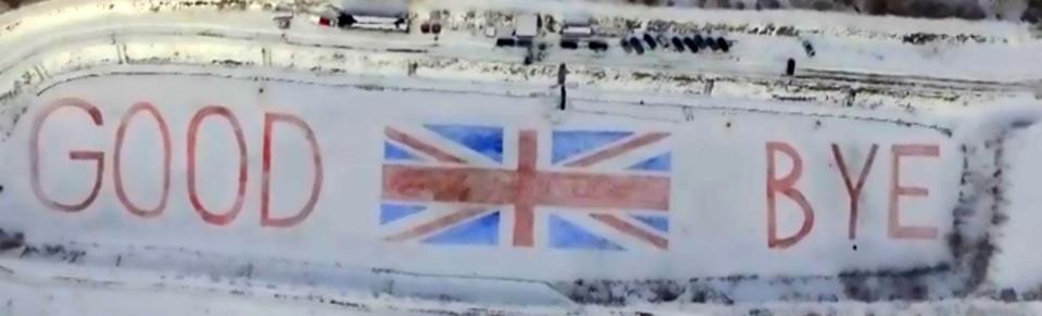  A group of Slovakian artists gave Britain a cheeky Brexit send-off by dyeing a huge 'GOOD BYE' and the Union Jack on a frozen lake