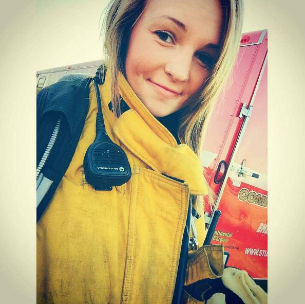  Another beautiful firewoman poses in her overalls for a quick selfie while on duty