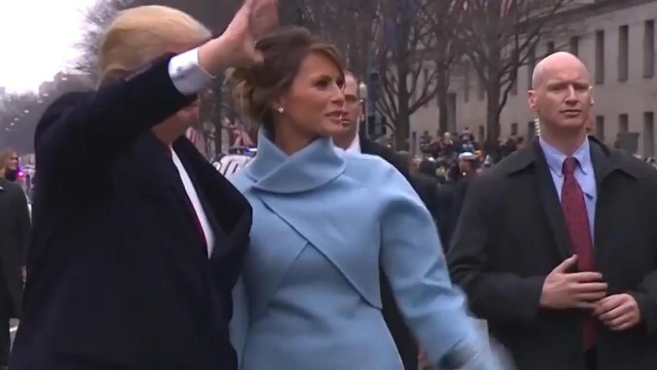  The bodyguard can be seen walking along holding his little finger between his other hand