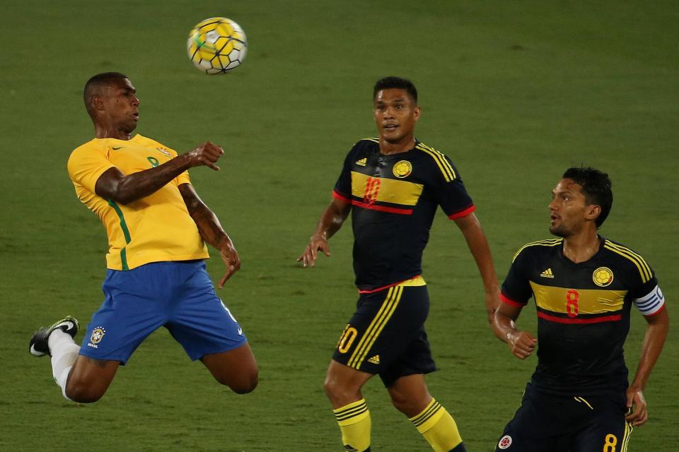  Brazil star Wallace rises for a header during the charity match