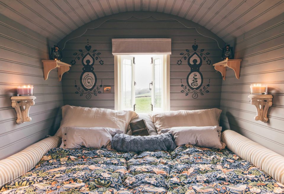  One wagon contains a cosy bedroom with a window that frames stunning views of the Cornish countryside