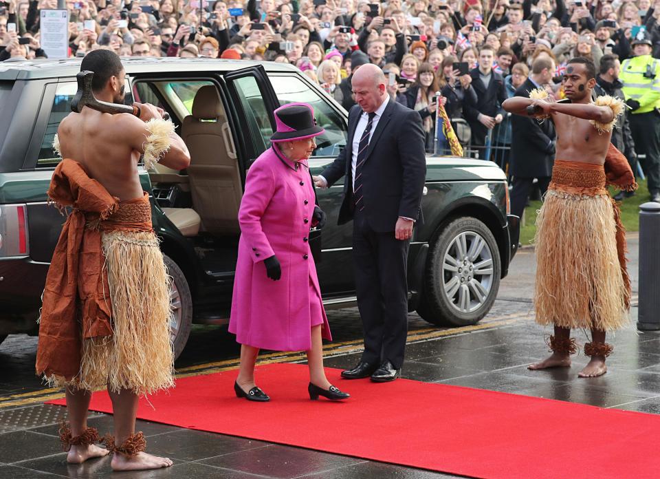  As the Queen stepped out onto the red carpet she was greeted by two warriors dressed in traditional Fijian clothing