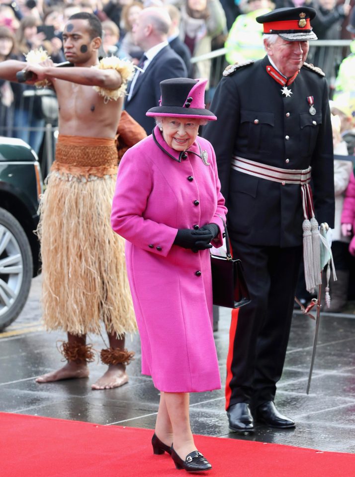  The Queen looked delighted to be greeted by the two warriors in traditional clothing