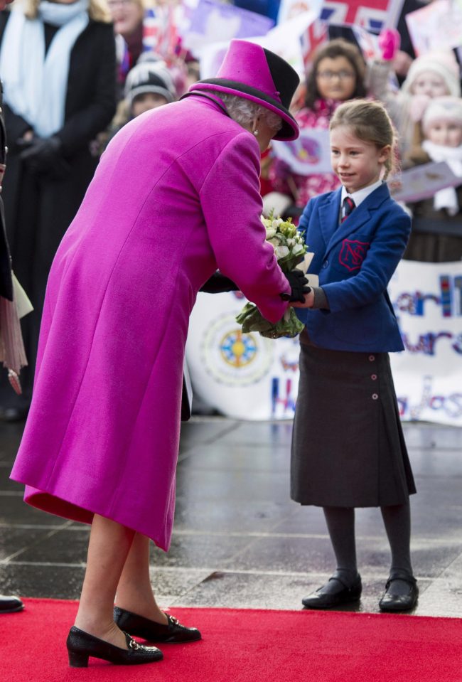  The Queen is handed flowers by a young schoolgirl as she arrived at the exhibition