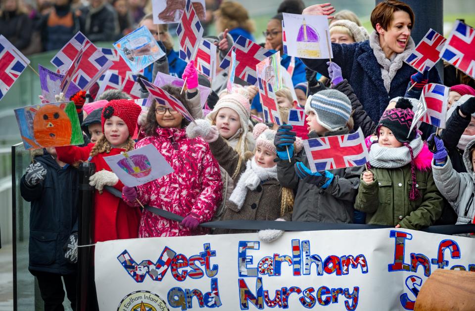  Crowds of excited children and adults gathered at the university building to welcome the Queen