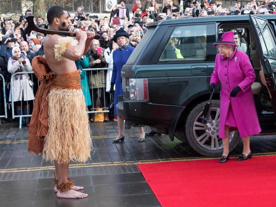  Her Majesty glanced over at one of the warriors guarding her red carpet as she arrived