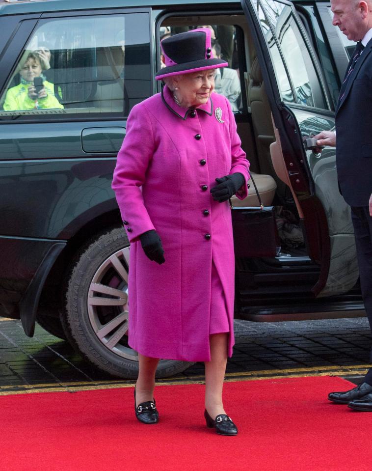  She wore a pink coat and hat teamed with black gloves for the exhibition