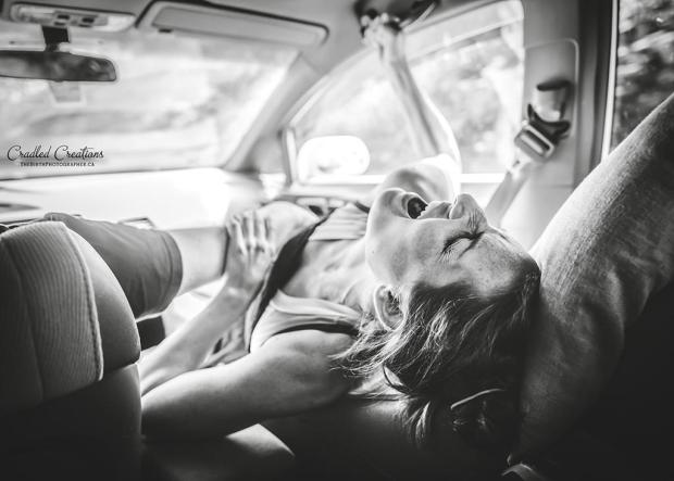 A mother screams in agony as her partner comforts her