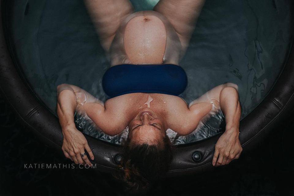  This captures to focus on a woman's face as she prepares for a waterbirth