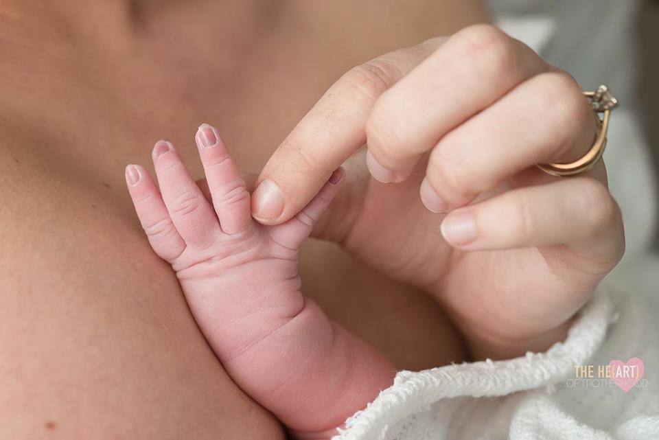  She holds her daughter’s fingers in awe and wonder - by The He{ART} of Motherhood