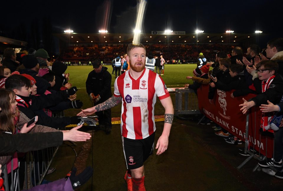  Power high fives Lincoln fans as he walks off the pitch