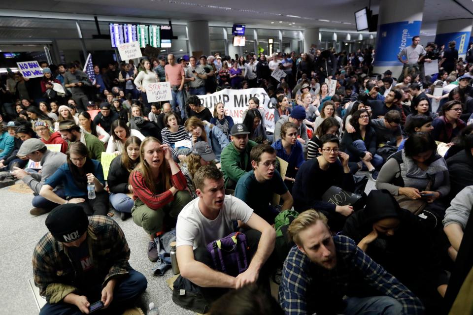  Protesters stage a sit-in in the arrivals terminal at San Francisco International Airport to denounce Trump's executive order