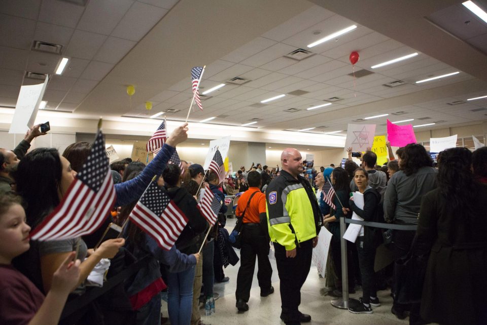  Protesters rally against the order at Dallas-Fort Worth International Airport