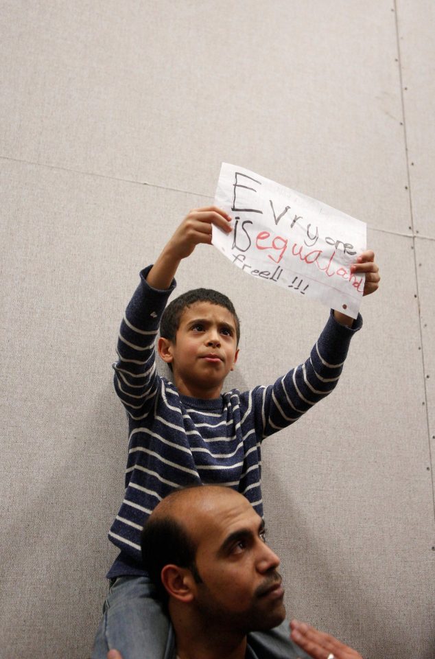  Mahmoud and his son Nour, 7, join the protest at Dallas-Fort Worth International Airport