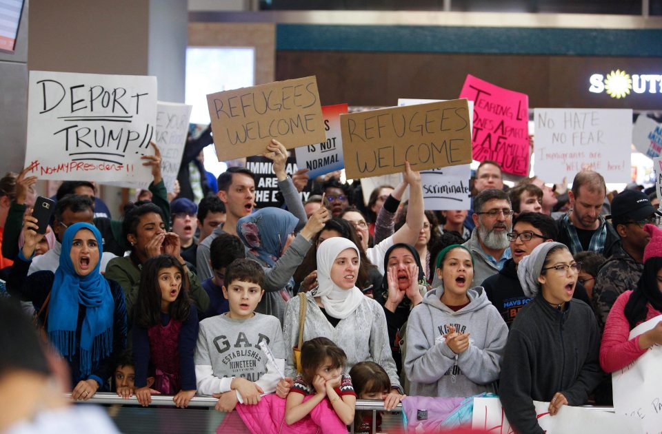  Protesters holding signs condemning the ban gathered at Dallas-Fort Worth International Airport last night