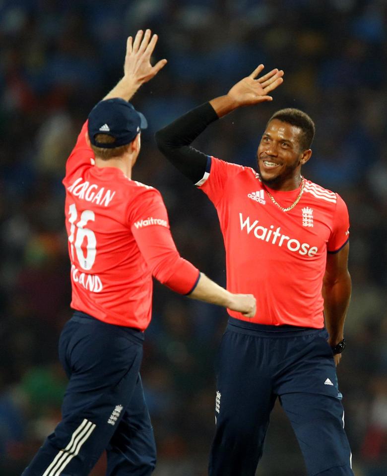  England's Chris Jordan celebrates with team mate Eoin Morgan the wicket of India's captain Virat Kohli