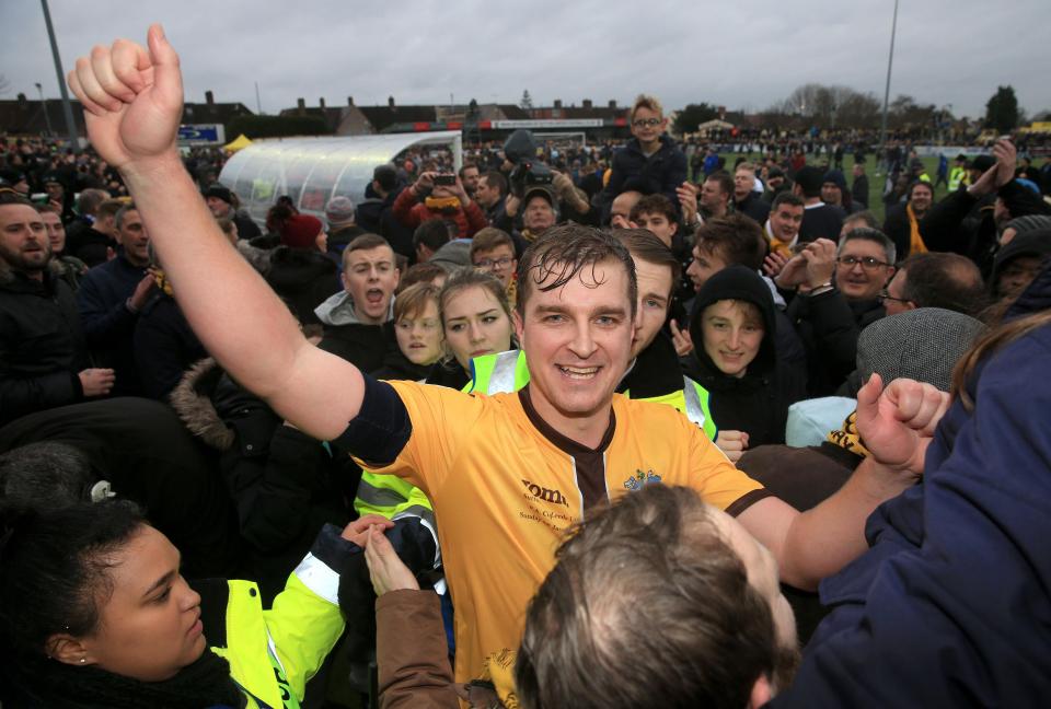  Goalscorer Collins was swarmed by fans during the pitch invasion