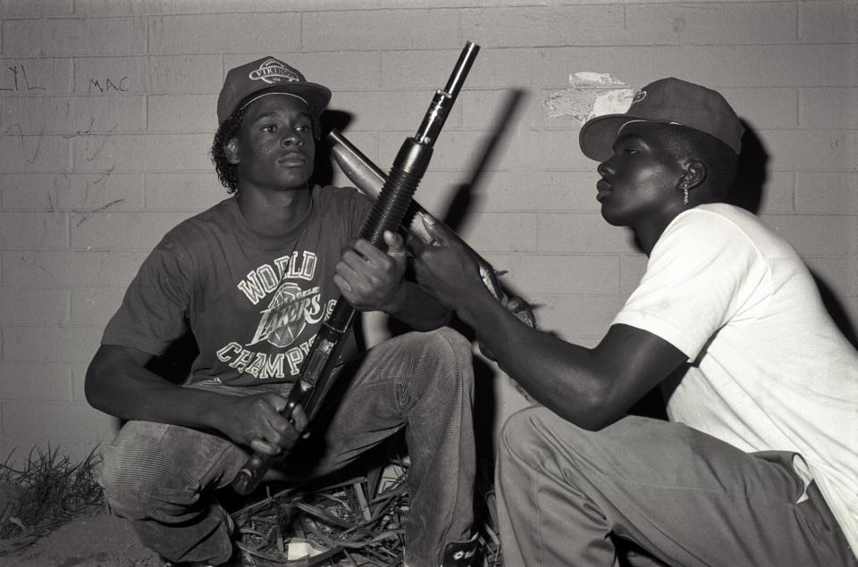  Posing with shotguns, these members of the gang wear their signature Vikings hats