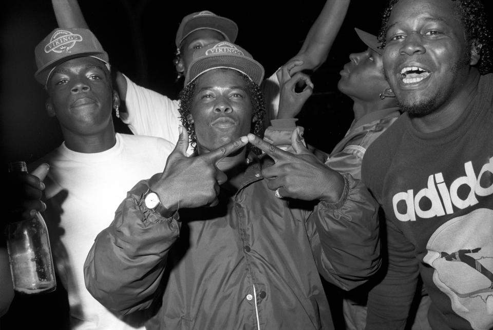  Members of the same branch throw the G and W sign to show their allegiance to the Grape Street Watts crew