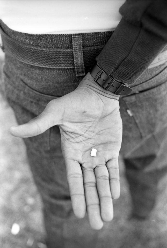  Drug dealing forms a large part of the gang's illegal activities. Here, a member of the Dodge City Crips poses with a rock of crack cocaine