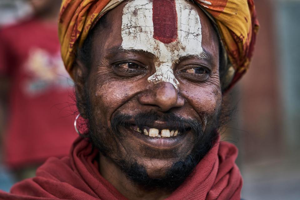  A holy man with a paint face smiles