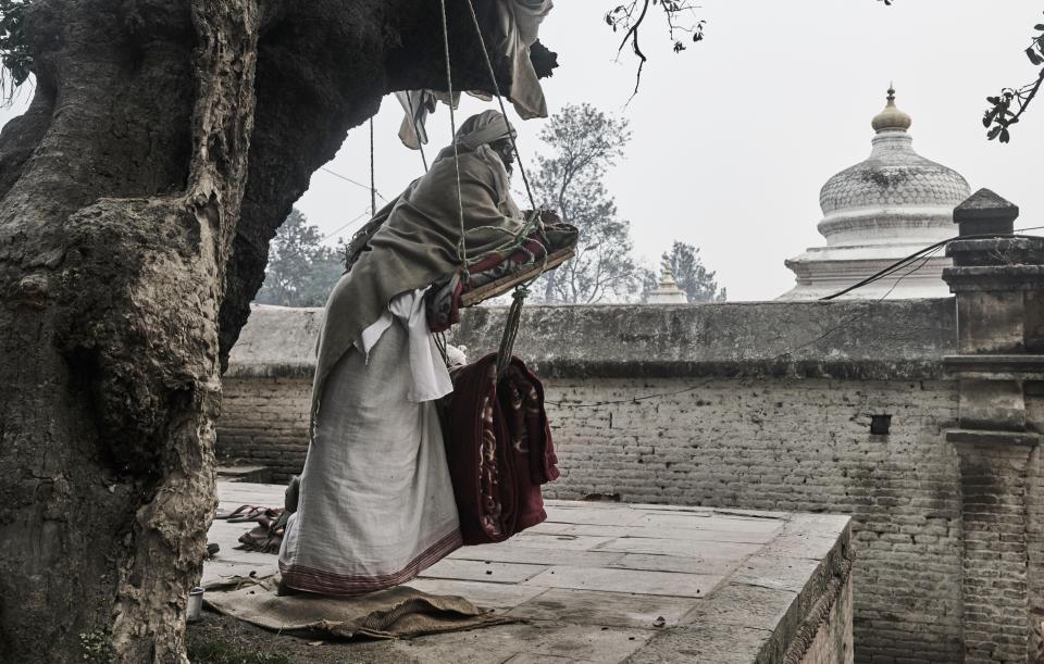  A holyman leans on a swing chair