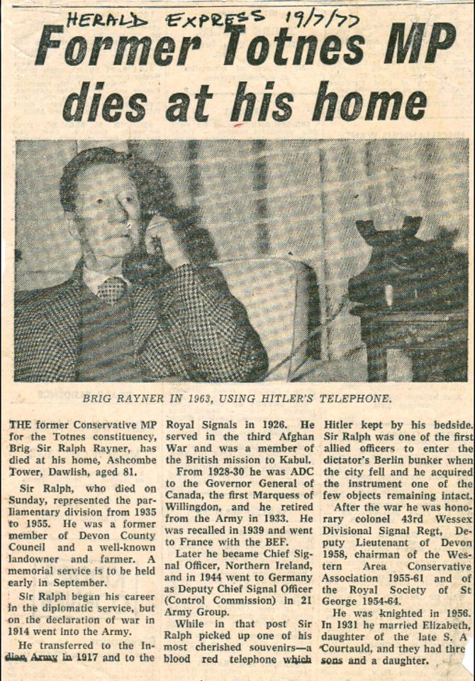  Press cutting of Brigadier Rayner's obituary in 1977 in the Torquay Herald Express, where he is pictured holding Hitler's phone