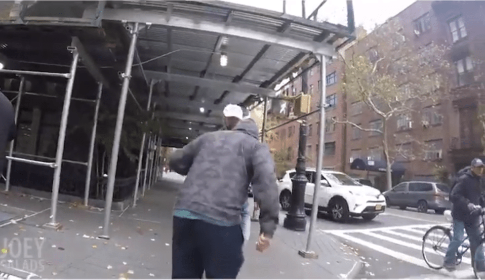 At another point in the video, one man spits on the ground in front of Salads as he walks down the street 