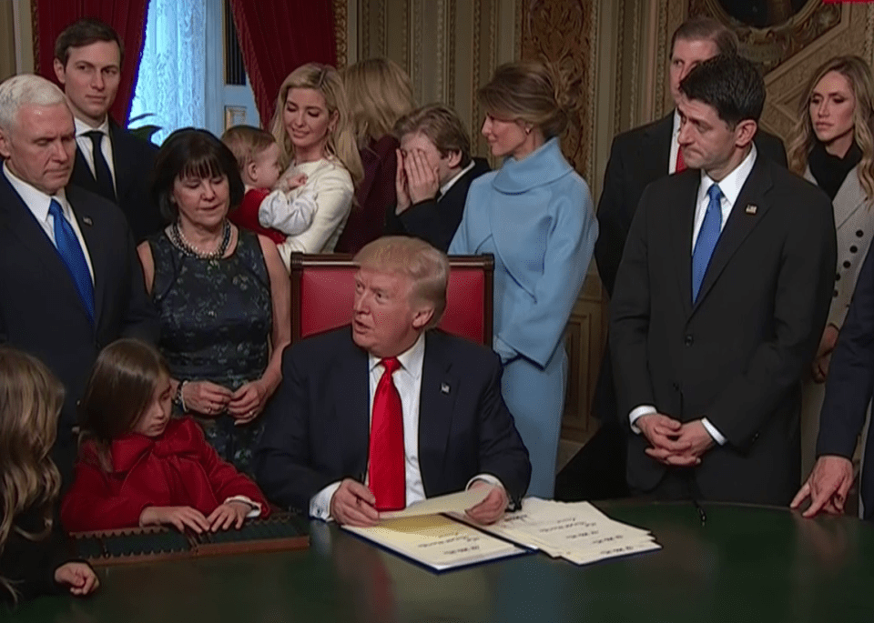  Trump seemed to find it funny and laughed along with his family, pictured is his wife Melania in blue and their son Barron, 10, covering his face