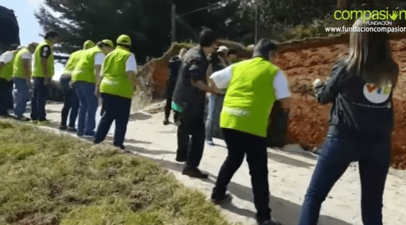  Volunteers all work together to improve the youngster's home