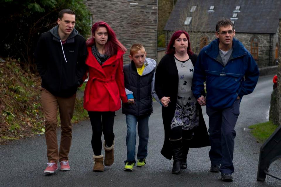  Jazmin Jones, in red coat, pictured with her family as they watch Mark Bridger's house being razed to the ground