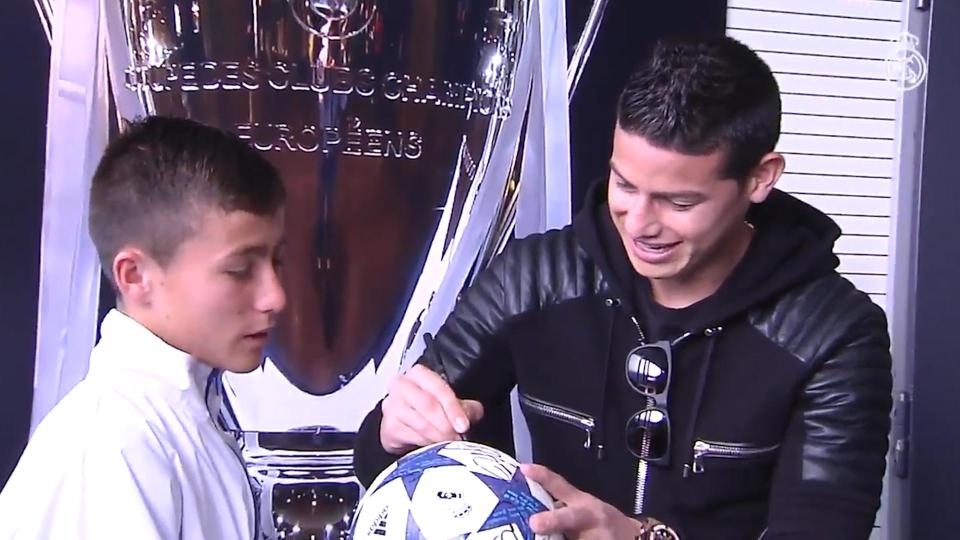  Rodriguez signs a football for the 15-year-old