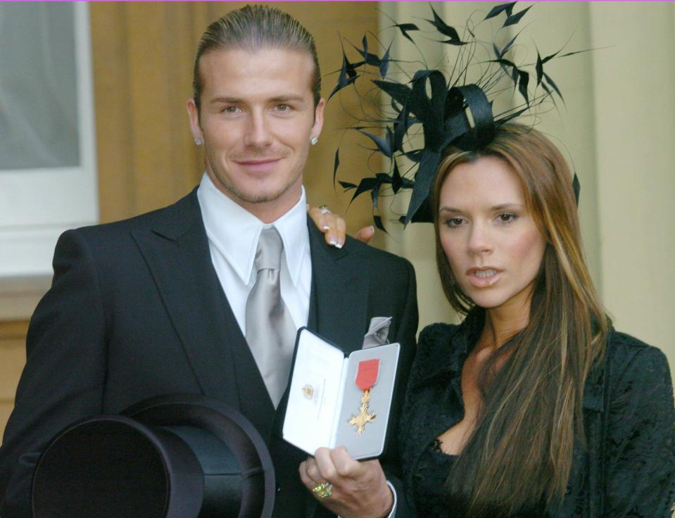  Former footballer David, pictured with wife Victoria, received an OBE in 2003