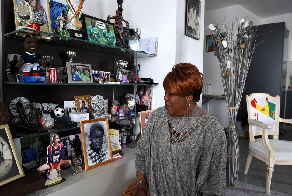  The Pogba brothers mother proudly stands next to medals they have won throughout their career