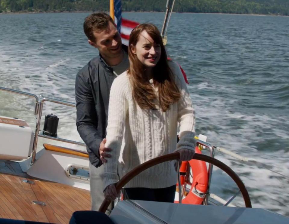  Ana laps up Christian's attention when he teaches her to steer his boat