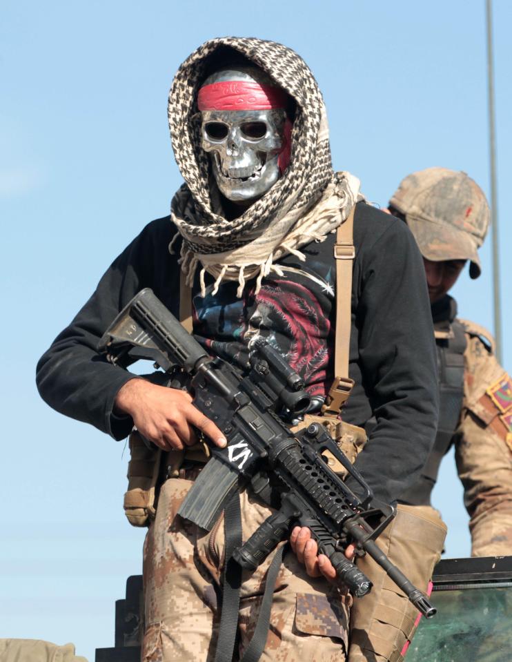  A masked Iraqi counter-terrorism service member east of Mosul