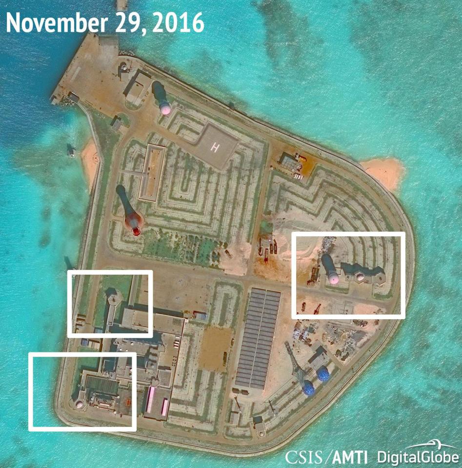  What appear to be anti-aircraft guns and what are likely to be close-in weapons systems (CIWS) on the artificial island Johnson Reef in the South China Sea