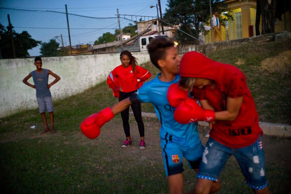  Boxer Idamerys Moreno, centre back, looks at children playing around