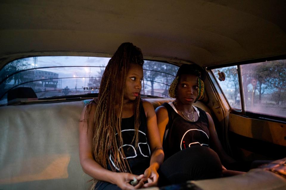  Boxers Idamerys Moreno, left, and Legnis Cala, ride home in a taxi after training