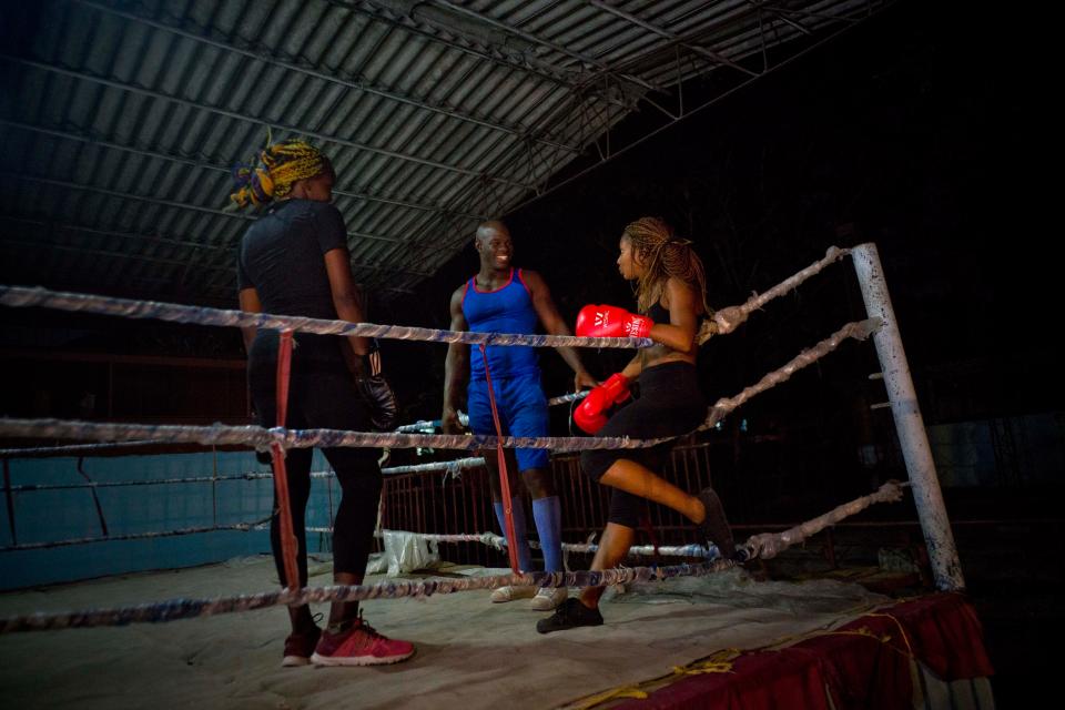  Olympic silver medalist Emilio Correa Jr., center, instructs Idamerys Moreno, right, and Legnis Cala, at a sports centre